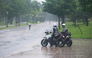 Moto refs take a break in the driving rain during the men's race. Photo: Casey B. Gibson | www.cbgphoto.com